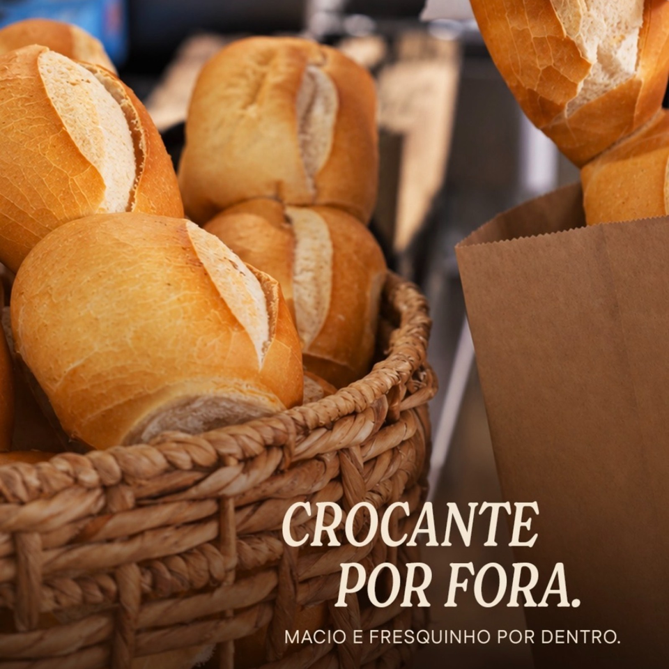 Fresh crusty bread rolls arranged in a woven basket beside a paper bag, with Portuguese promotional text.